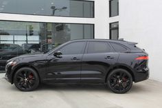 a black car parked in front of a building