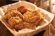 fried food in a basket on a wooden table