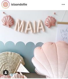 there is a sign that says maa on the wall next to some pillows and other items