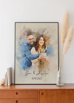 a watercolor painting of a couple holding each other on top of a wooden dresser