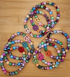 Peace sign multi color stretch stack boho bead bracelets - pick your favorite bohemian color.  Each bracelet is 7 1/2 inches long.  Created by Kelly in the USA! Please do not over stretch, may result in breakage.  Never leave small children unattended with items containing small pieces, potential choking hazard.  Beads may change colors over time if worn in water or while applying products to the skin such as lotions. Check out my Etsy store for bracelets and more Kellyanndesigsgifts.etsy.com Bohemian Stretch Bracelet With Letter Beads For Festivals, Bohemian Beaded Bracelets With Letter Beads For Festivals, Hippie Colorful Beaded Summer Bracelets, Bohemian Stretch Bracelet With Round Beads, Adjustable Multicolor Hypoallergenic Stretch Bracelet, Festival Bohemian Beaded Bracelets With Letter Beads, Artsy Multicolor Beaded Bracelets As Gift, Artsy Multicolor Beaded Bracelets For Gifts, Bohemian Multicolor Beaded Bracelets With Letter Beads