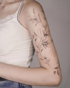 a woman with a flower tattoo on her arm