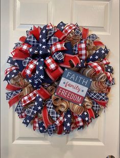 a patriotic wreath on the front door with a faith for freedom sign and red white and blue ribbons