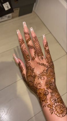 a woman's hand with henna on it