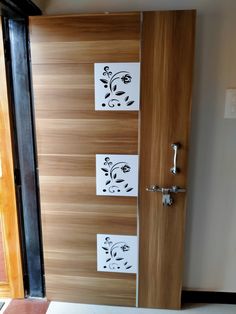 a wooden door with three stickers on the front and side panels that have flowers painted on them