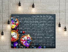 a chalkboard with some fruit on it in front of hanging lights and black lamps