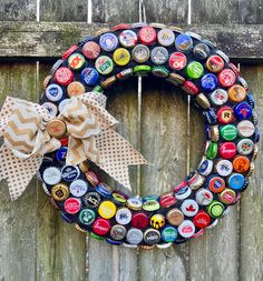 a bottle cap wreath on a wooden fence