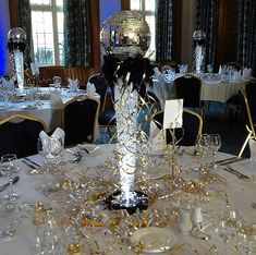 there is a disco ball on top of the table in this room with silver and gold decorations