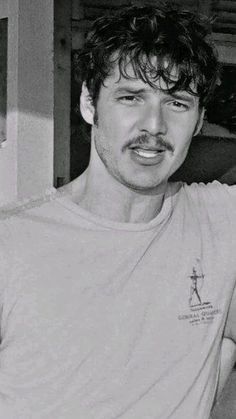 a black and white photo of a man with a mustache