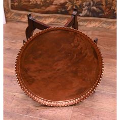 a brown leather tray sitting on top of a wooden floor