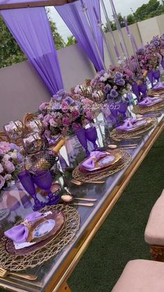 a long table with purple and gold decorations