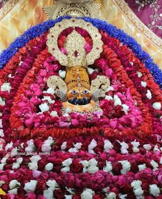 the statue is surrounded by flowers and other decorations