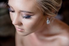 a close up of a woman's face with blue eyeliners and eyelashes