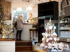 a small christmas tree is in the middle of a room with other items on display