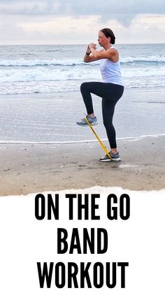 a woman standing on top of a beach next to the ocean holding a baseball bat