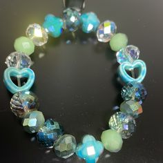 Crystal Handmade One Of A Kind Stretch Bracelet Blue Green With Ab Crystals And Heart Detail Handmade Light Blue Beaded Bracelets, Trendy Blue Beaded Bracelets For Party, Adjustable Blue Party Bracelets, Blue Bohemian Crystal Bracelet For Gift, Trendy Adjustable Blue Crystal Bracelet, Trendy Blue Charm Bracelet With Round Beads, Bohemian Blue Crystal Bracelet For Gift, Bohemian Blue Crystal Bracelet Gift, Trendy Blue Beaded Charm Bracelet