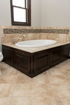 a bath tub sitting in the middle of a bathroom next to a toilet and sink