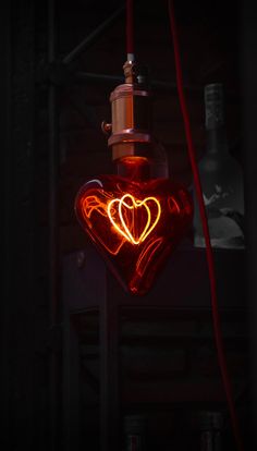 a heart shaped light hanging from a ceiling