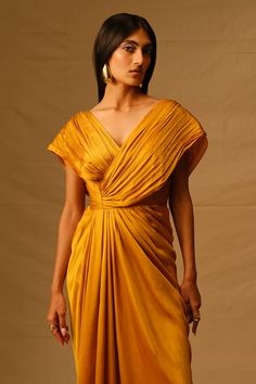 Mustard voile full length dress with criss cross pleated bodice. - Aza Fashions Mustard Silk Dress, Silk Pleated V-neck Maxi Dress, Pre-draped Maxi Dress With Folds, Silk V-neck Pleated Dress, V-neck Maxi Dress With Pleated Back For Wedding, Silk Floor-length Dress With Folds, Floor-length Silk Dress With Folds, Pre-draped V-neck Maxi Dress For Cocktail, Pre-draped V-neck Dress With Pleated Bodice