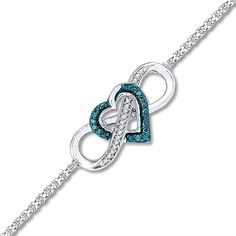 An infinity symbol winds around a heart outlined in blue diamonds as the centerpiece of this attractive bracelet for her. A row of sparkling white diamonds completes the look, bringing the total diamond weight to 1/10 carat. Styled in sterling silver, the centerpiece is attached with a 7.5-inch rope chain that secures with a lobster clasp. Blue diamonds are treated to permanently create the intense blue color. Diamond Infinity Bracelet For Anniversary, Infinity Diamond Bracelet For Anniversary, Infinity Diamond Bracelet With Accents For Anniversary, Anniversary Diamond Bracelet With Infinity Design, Diamond Infinity Bracelets For Anniversary, Silver Bracelet Designs, Popular Bracelets, Bracelet For Her, Blue Diamonds