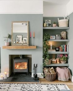 a living room filled with furniture and a fire place in front of a mirror on the wall