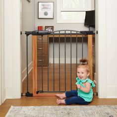 Safety meets innovation in the Toddleroo by North States Deco WoodCraft Steel Gate with Auto Close. This sturdy baby safety gate has a beautiful realistic woodgrain finish on a heavy-duty graphite steel frame with an arched door. This truly unique wood grain design is so realistic looking, you won’t believe it’s not wood! This gate is packed with safety features and can be used in virtually any room or at the bottom of stairs. The extra wide 22-inch gate door swings open in either direction and Pocket Door Pet Gate, Pocket Pet Gate, Extra Wide Baby Gate, Barn Door Baby Gate, Baby Safety Gate, Staircase Gate The Stair Barrier Baby & Pet Safety Gates, Safety Gate, Baby Gate, Steel Gate