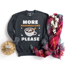 This festive Hot Cocoa Shirt is a wonderful holiday or winter gift for family, friends, or loved ones. This fun graphic design is great for a hot chocolate lover or drink enthusiast who loves Christmas and winter apparel. It can be printed on a T-shirt, sweatshirt, tank top, or hoodie. *  UNISEX SHIRT  * The T-Shirt is lightweight and soft to the touch, with the perfect amount of stretch. Super comfortable with the unisex cut flattering on both men and women. A best-selling favorite among many c Family Matching Winter Tops For Gifts, Pre-shrunk T-shirt As Winter Gift, Winter Gift Cotton T-shirt, Cotton T-shirt For Winter Gift, Cute Hot Cocoa, Winter Apparel, Classic Wardrobe Staples, Winter Shirts, Chocolate Lover