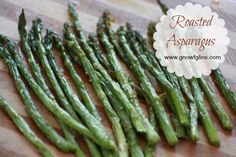 asparagus on a cutting board with the words roasted asparagus