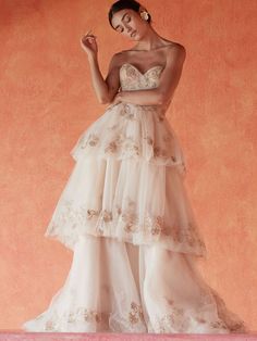 a woman in a wedding dress posing for the camera with her hand on her hip