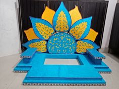 an elaborate blue and yellow sculpture in the shape of a flower