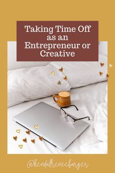 an open laptop computer sitting on top of a bed next to pillows and coffee mug