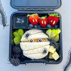 a bento box with fruit and vegetables in it