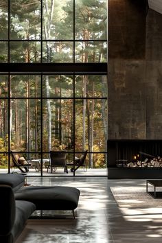 a living room with large windows and a fireplace