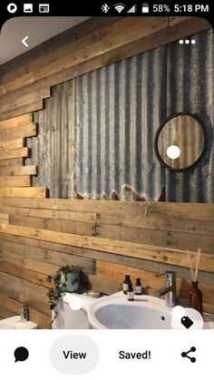 the bathroom is made out of wood and has an old tin sheet on the wall