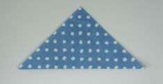 a blue triangle with white polka dots on it