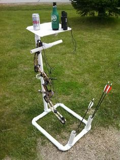 an upside down table with fishing gear on it in the middle of a grassy field