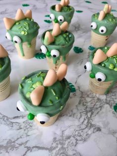 some cupcakes with green frosting and googly eyes