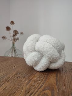 a white object sitting on top of a wooden table