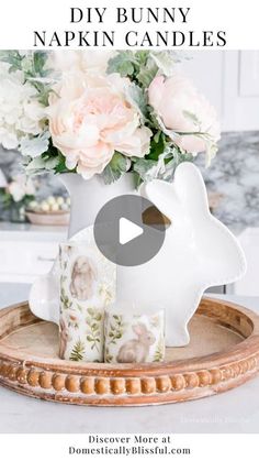 a vase with flowers in it sitting on top of a wooden tray and the words diy bunny napkin candles