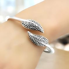 Embrace elegance and nature's beauty with our handcrafted Lightweight 925 Sterling Silver Dotted Leaf Design Bangle Bracelet. This exquisite piece is a symphony of delicate craftsmanship and timeless style, designed to elevate your everyday look with a touch of sophistication. Fashioned from premium 925 sterling silver, this bangle boasts a unique hollow form, ensuring it is as light as a feather on your wrist while maintaining its strength and durability. The intricate dotted leaf pattern etched across the bracelet's surface captures the essence of a serene forest, bringing a peaceful charm to your ensemble. Sized at 6 1/2 inches (16.5 cm) in inside circumference, our bangle bracelet is designed to fit comfortably around your wrist, making it an ideal accessory for daily wear or special o Silver Bangle Bracelet As Gift For Her, Dot Leaf, Serene Forest, Dotted Design, Hollow Form, Dots Design, Birthday Present, Silver Leaf, Leaf Design