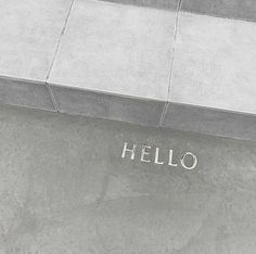 a concrete bench with the word hello written on it