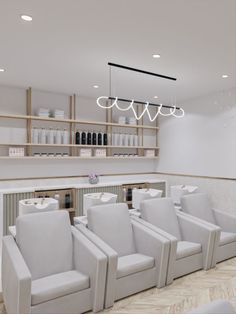 the interior of a salon with white chairs