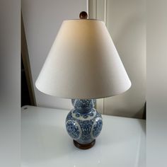 a blue and white lamp sitting on top of a table