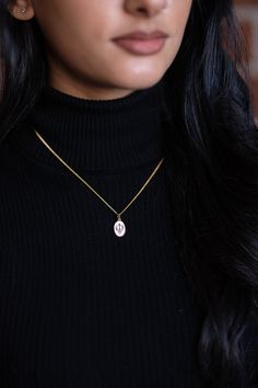 The Mini Ek Onkar Pendant necklace for women is a beautiful reminder of our source of strength and love. Made in 925 Sterling Silver that is layered in 18kt gold, with an enameled pendant and a polished chain, it is a wonderful addition to every moment. *Pendant Size: 14mm x 10.5mm *Chain length: 16"-18" adjustable *Material: Made in 925 Sterling Silver then layered in 18kt gold. *Capture shows the companion Mini Khanda Necklace design. Same size as Mini Ek Onkar necklace. Gold Plated Hallmarked Charm Necklaces, Hallmarked Gold Plated Charm Necklaces, Initial Necklace With Charms And Round Pendant, Silver Oval Pendant Charm Necklace In Gold Plated, Sterling Silver Medallion Charm Necklace, Spiritual 14k Gold Charm Necklaces, Gift Oval Pendant Necklace Tarnish Resistant, Tarnish Resistant Oval Pendant Necklace As Gift, Tarnish Resistant Oval Pendant Necklace For Gift