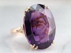 "This is one outstanding cocktail piece! We've set this stunning amethyst in a sleek yellow gold vintage mounting with alluring richness in color, sheer size, and the way the mounting presents the stone! The gold mounting has a lovely filigree undercarriage allowing maximum light into the stone allowing it to sparkle and radiates its stunning color. This piece is all about the rich beauty of this amethyst, truly a fantastic statement piece! Metal: 10K Yellow Gold Gem: Amethyst 27.08 Carats Gem M Yellow Gold Amethyst Ring, Amethyst Cocktail Ring, Seed Pearl Ring, Gold Amethyst Ring, Crystal Goddess, Unusual Rings, Amethyst Jewelry, Yellow Gold Pendants, Victorian Jewelry