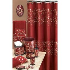 a bathroom with red and white decor on the shower curtain, toiletries and rugs