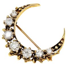 A staple of the Victorian jewelry, this crescent is a perfect example of gold craft from that period circa 1890-1900. The crescent is made in 14-karat yellow gold and features 7 graduated old mine-cut diamonds prong set. The estimated weight of the diamonds is 1.50 carats, HI color, and SI clarity. The piece has a gross weight of 4.8 grams and measures 1.16” wide. Victorian Crescent Jewelry As Gift, Victorian Crescent Jewelry For Gifts, Victorian Crescent Jewelry Gift, Gold Crescent Brooch Jewelry, Victorian Crescent Wedding Jewelry, Vintage Gold Crescent Brooch, Vintage Gold Crescent Brooches, Vintage Crescent Brooch For Gift, Moon And Star Design