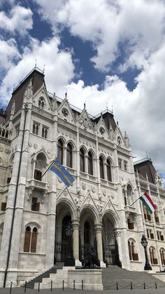 a large white building with two flags on it's sides