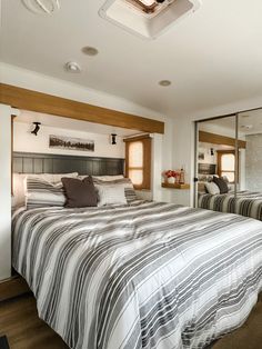 a bedroom with two beds and mirrors in it