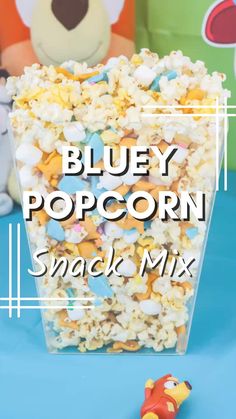 bluey popcorn snack mix in a plastic container with a toy car next to it